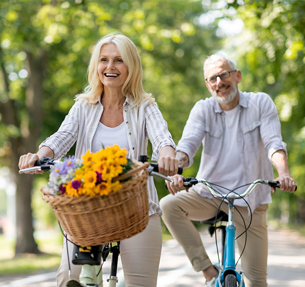 cheerful retired couple riding bicycles successful retirement